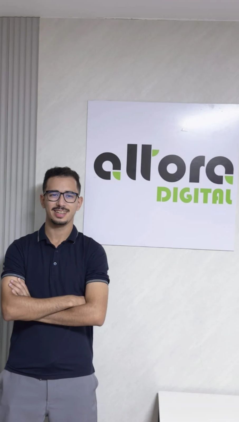 Membre de l'équipe Altora Digital devant le logo de l'agence